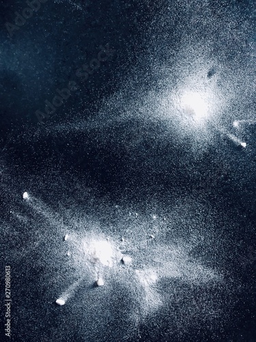 Baking Soda splashed on tumbled black granite 