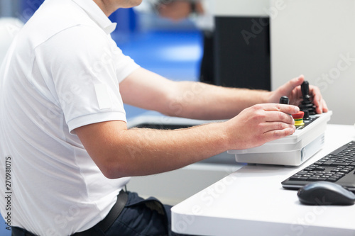 Canvastavla Technician is using joystick to operate electronic device