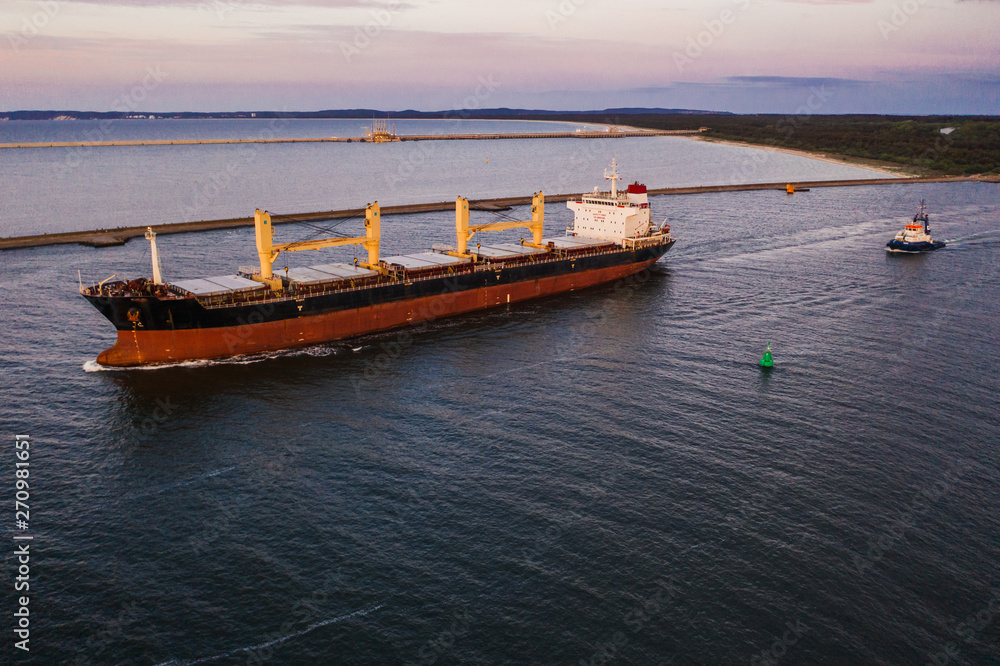 Naklejka premium Cargo ship leaving the port, northern Poland. 
