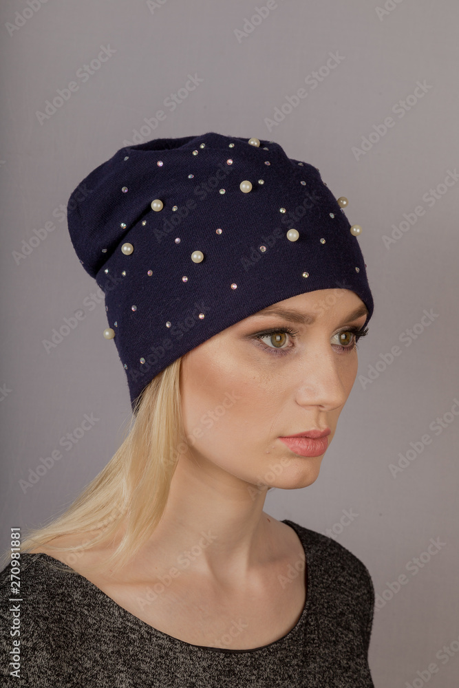 Beautiful girl with natural make-up in a headdress on a gray background. Beautiful girl with natural make-up in a headdress on a gray background.