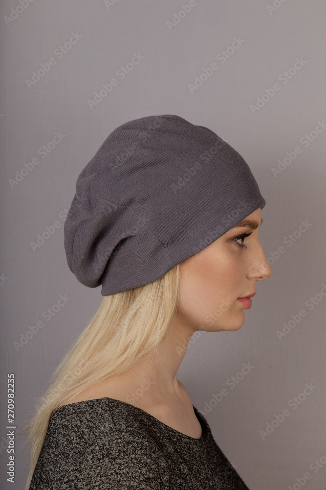 Beautiful girl with natural make-up in a headdress on a gray background. Beautiful girl with natural make-up in a headdress on a gray background.