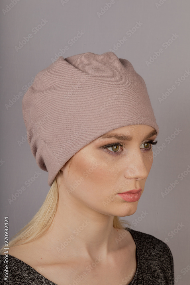 Beautiful girl with natural make-up in a headdress on a gray background. Beautiful girl with natural make-up in a headdress on a gray background.