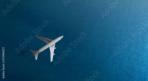 Aerial top view of Airplane flies over a sea, view from above