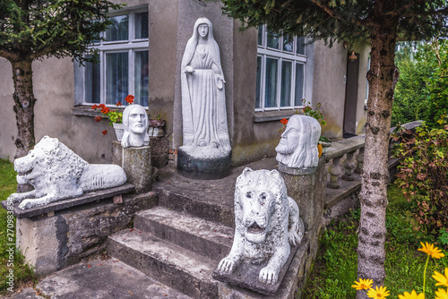 Sculptures of a lions, Virgin Mary and Jesus in front of a house in Lesno, small village in Chojnice County, Poland photo