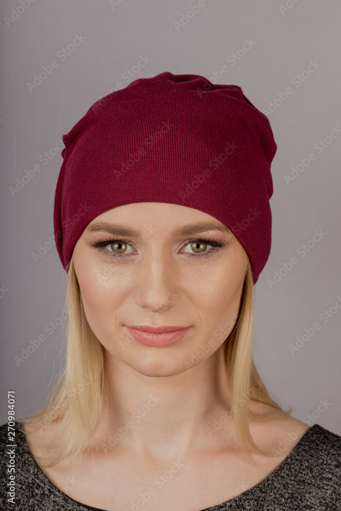 Beautiful girl with natural make-up in a headdress on a gray background. Beautiful girl with natural make-up in a headdress on a gray background.