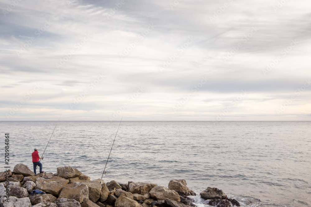 one man seafishing on the beach