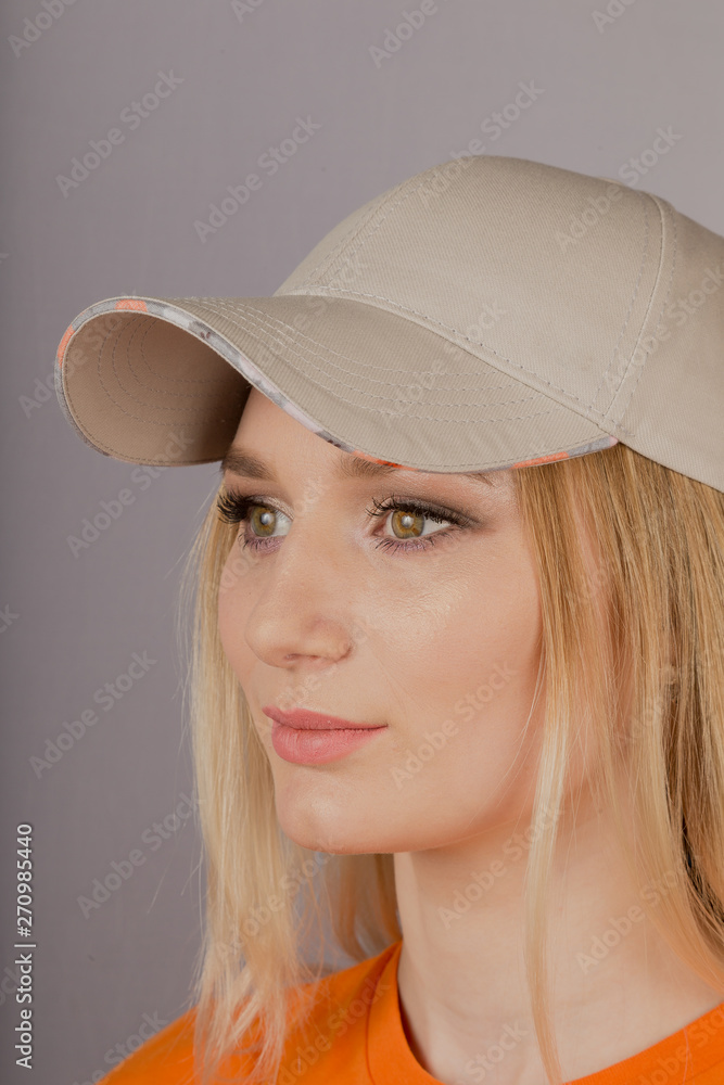 Beautiful girl with natural make-up in a headdress on a gray background. Beautiful girl with natural make-up in a headdress on a gray background.