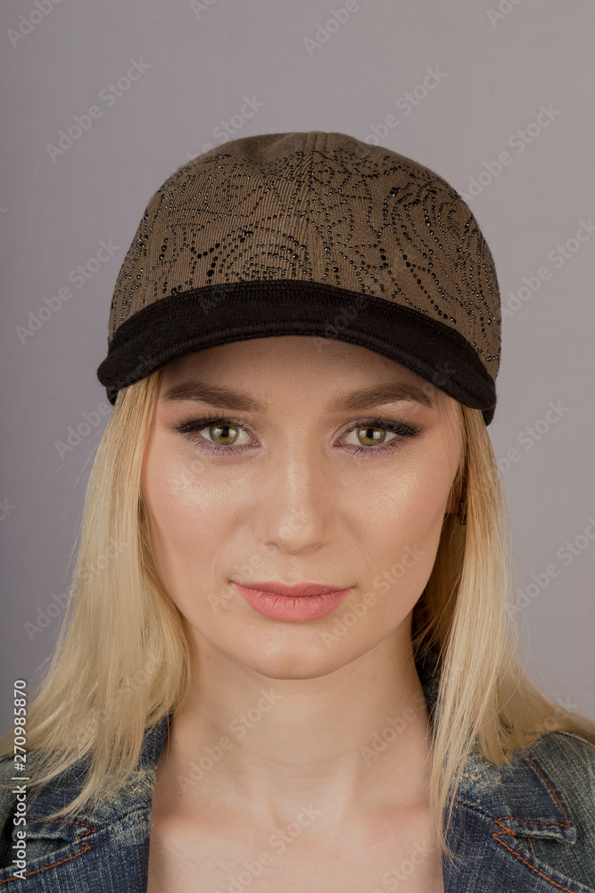 Beautiful girl with natural make-up in a headdress on a gray background. Beautiful girl with natural make-up in a headdress on a gray background.