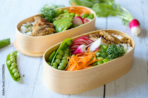 Japanese style bento lunch box with chicken, rice and vegetables