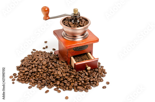Retro wooden coffee grinder on white background with coffee beans.