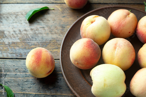 A group of ripe peaches in a bowl
