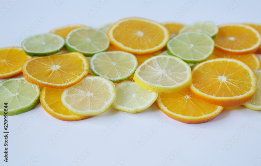 slices of orange and lemon, and lime isolated on white background. Colorful citrus slices pattern, background, texture. With copy space for text. slices of orange and lemon, and lime isolated on white background. Colorful citrus slices pattern, background, texture. With copy space for text.