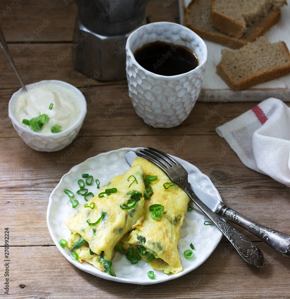 Homemade breakfast of omelet with asparagus and onions and hot coffee. Rustic style. Homemade breakfast of omelet with asparagus and onions and hot coffee. Rustic style.