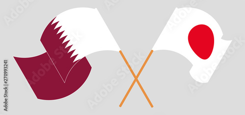 Crossed and waving flags of Japan and Qatar