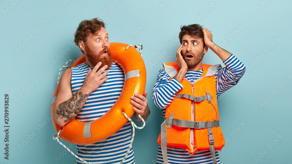 Emergency situation. Two scared professional male lifesavers surprised ...