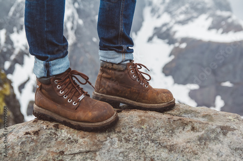 Tracking boots for a walking and adventure on a stone background. Travel lifestyle concept.