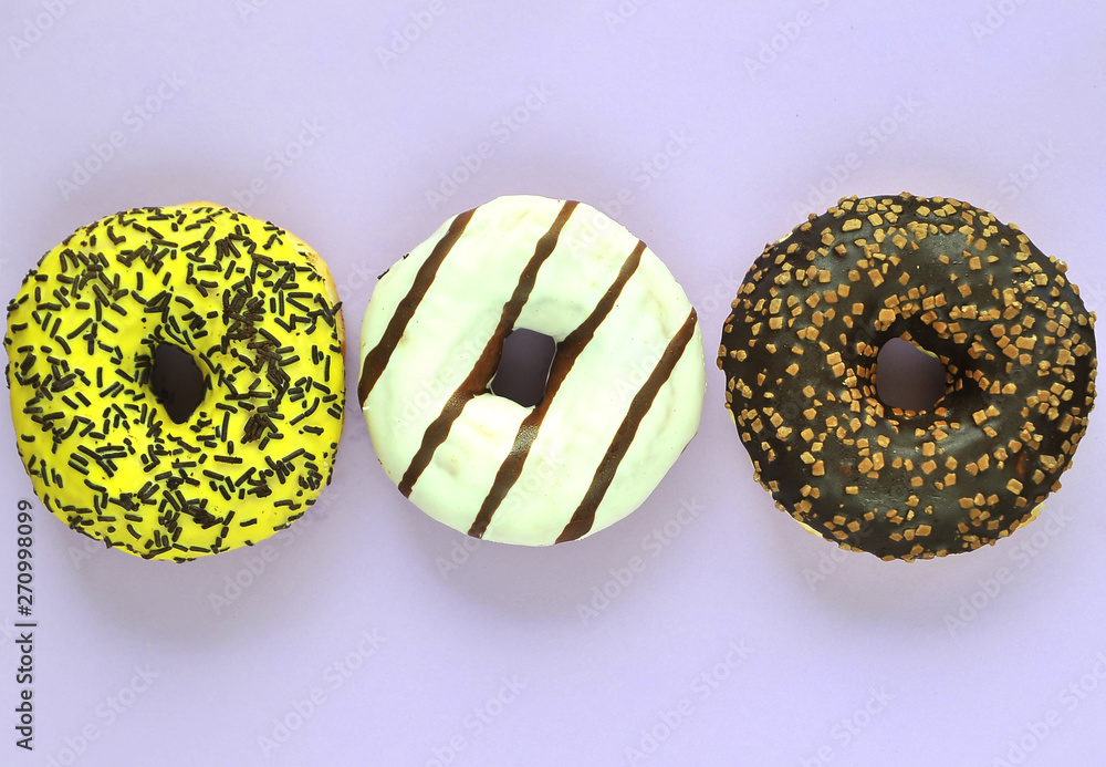 Delicious donuts on light pastel color background. Delicious donuts on light pastel color background.