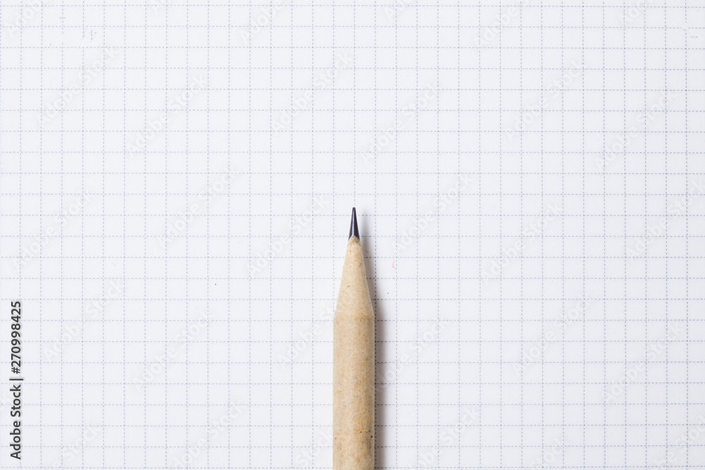 Pencil on blank grid note pad Pencil on blank grid note pad