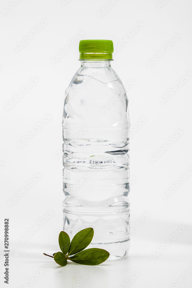 Green leaf with plastic drinking water bottle on white Green leaf with plastic drinking water bottle on white