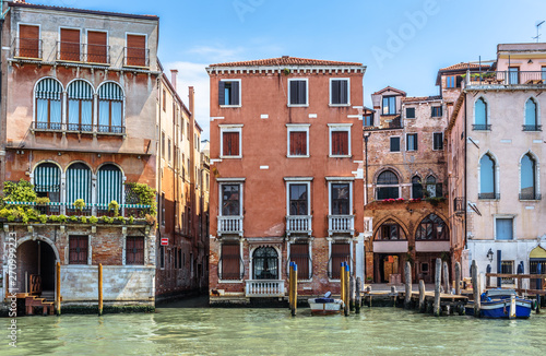 Old houses on Grand Canal, Venice, Italy. Vintage hotels and residential buildings in the Venice center. Historical architecture of Venice on water in summer. Venetian street with ancient facades. photo