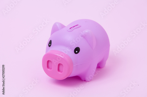 Piggy bank on soft pink background