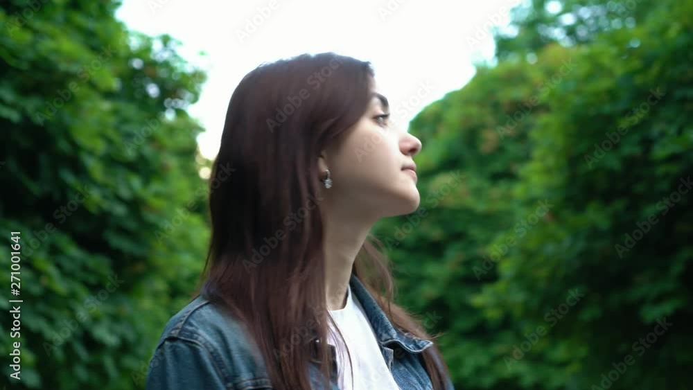 portrait of beautiful brunette young girl in nice mood in the park. Close up portrait of beautiful brunette young girl in nice mood in the park. Close up