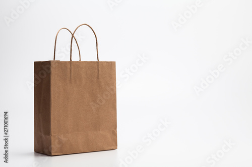 Empty Brown kraft shopping bag stand isolated on white background
