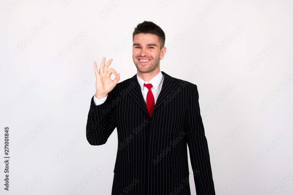 successful young businessman in black suit with red tie successful young businessman in black suit with red tie