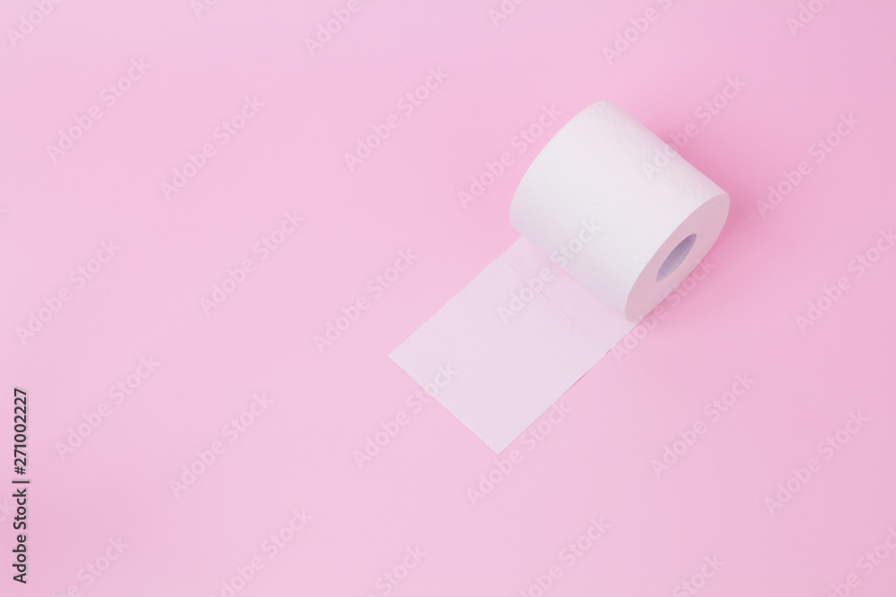 The roll of white toilet tissue paper on pink background The roll of white toilet tissue paper on pink background