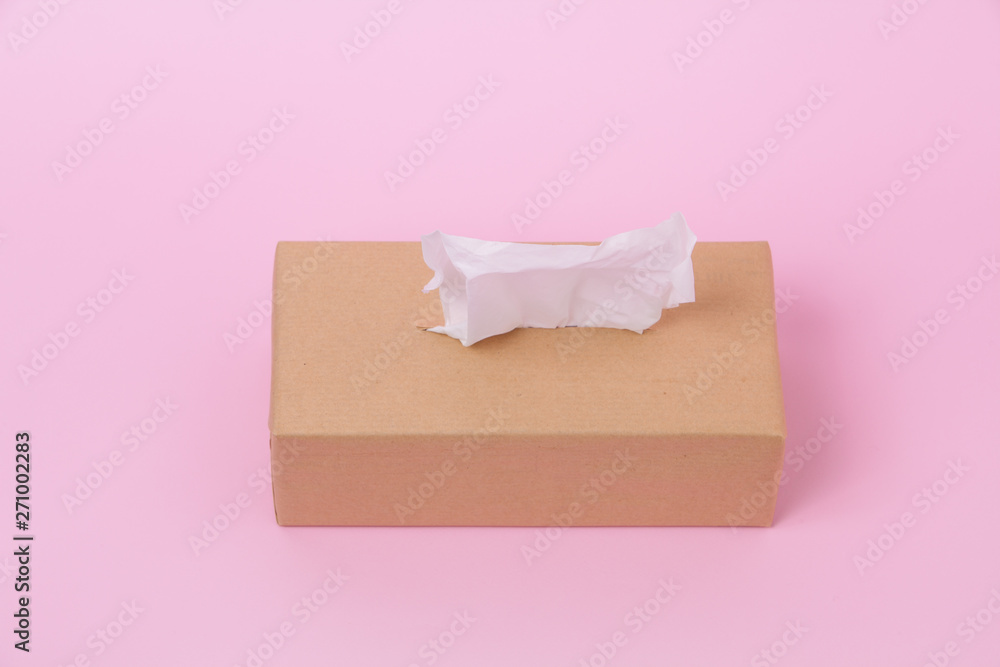 Box paper tissues with one sticking from the top on pink background Box paper tissues with one sticking from the top on pink background