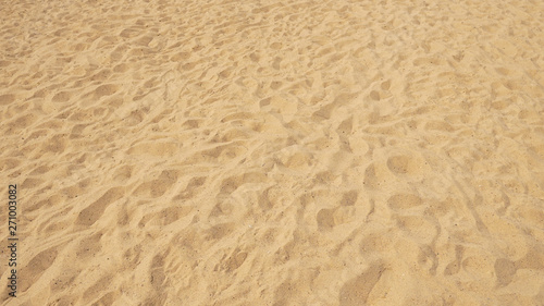 Сloseup of sand pattern of a beach in the summer.Sand texture. Sandy beach for background. Top view