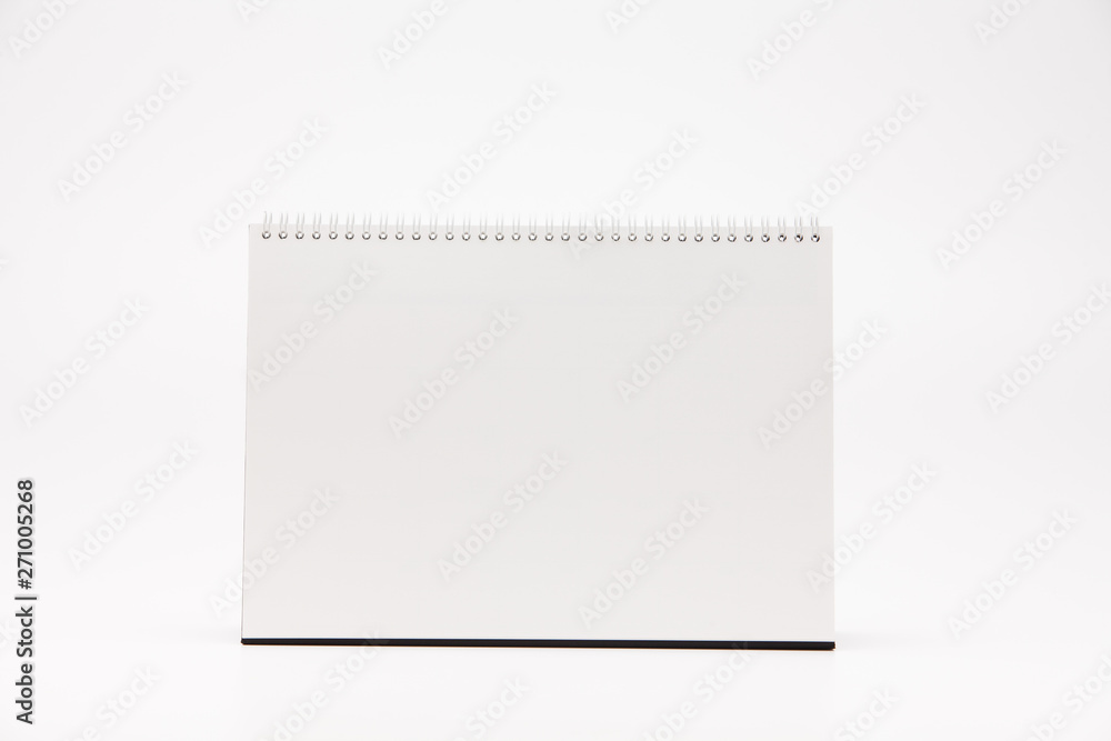 A white paper calendar stands on the table in photo A white paper calendar stands on the table in photo