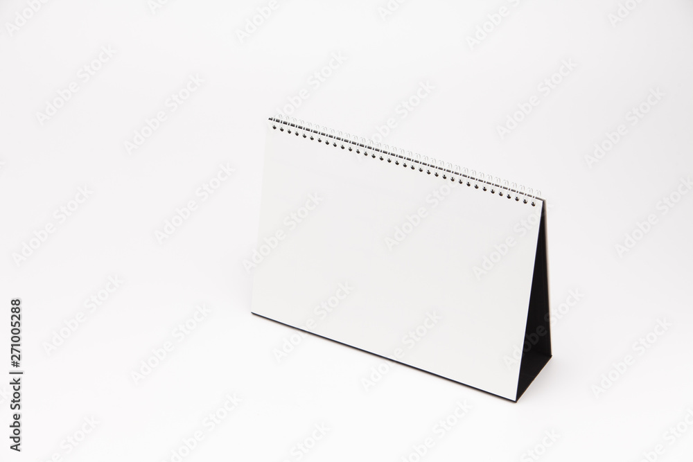 A white paper calendar stands on the table in photo A white paper calendar stands on the table in photo