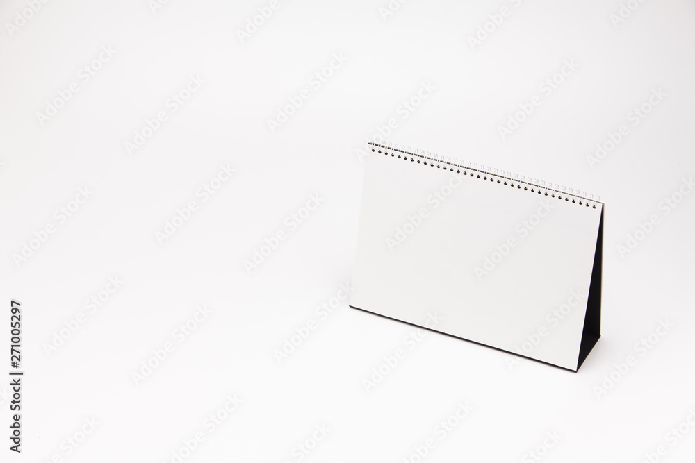 A white paper calendar stands on the table in photo A white paper calendar stands on the table in photo