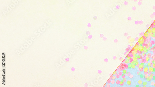 Confetti on abstract geometric paper background, festive concept.