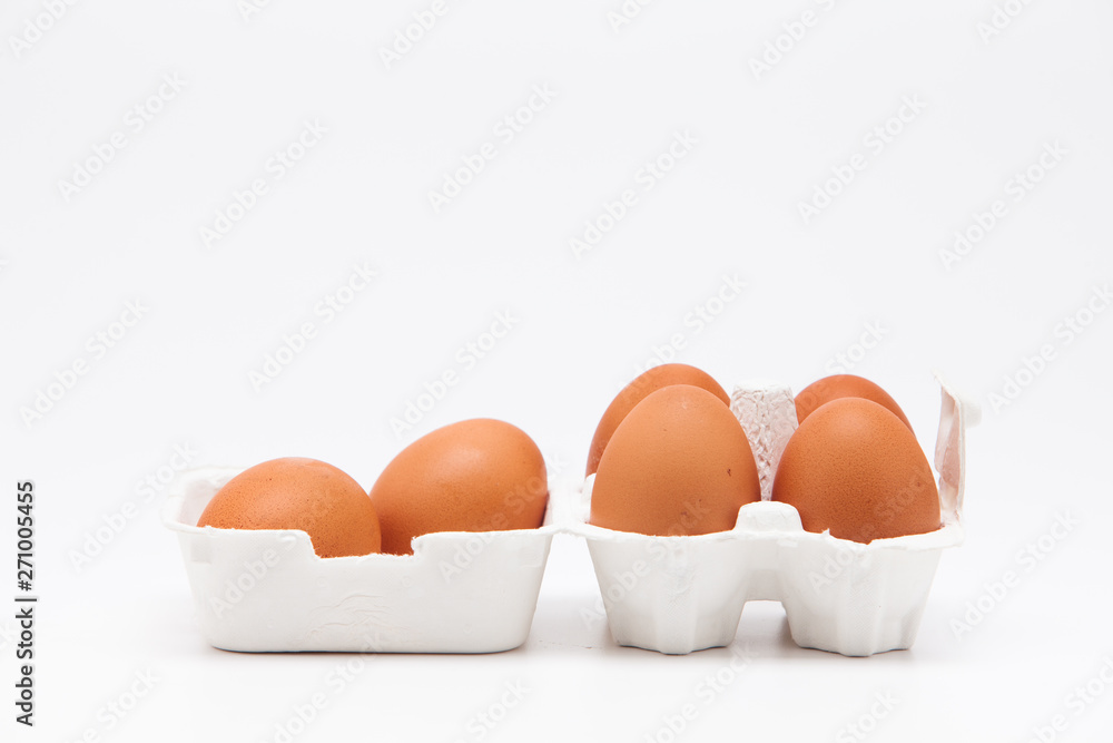 Brown eggs with white eggbox isolated on white background 