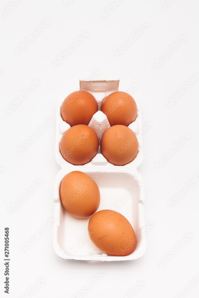 Brown eggs with white eggbox isolated on white background Brown eggs with white eggbox isolated on white background