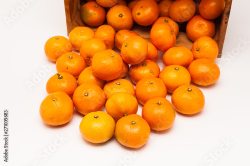 Mandarin tangerine in wooden crate isolated on white
