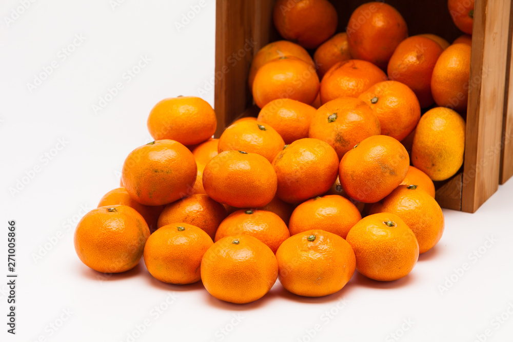 Mandarin  tangerine in wooden crate isolated on white