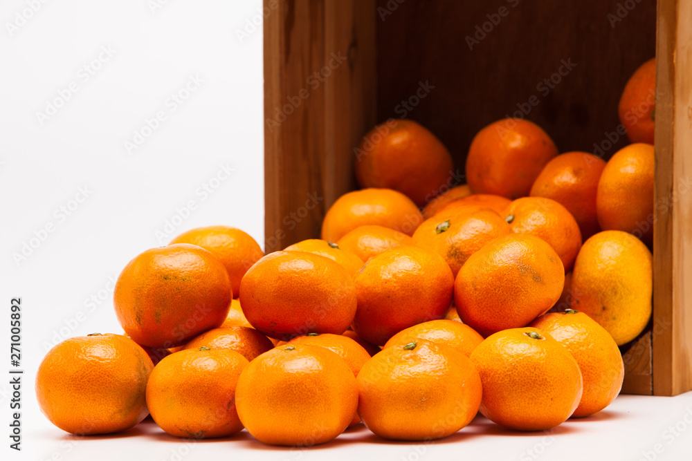 Mandarin  tangerine in wooden crate isolated on white