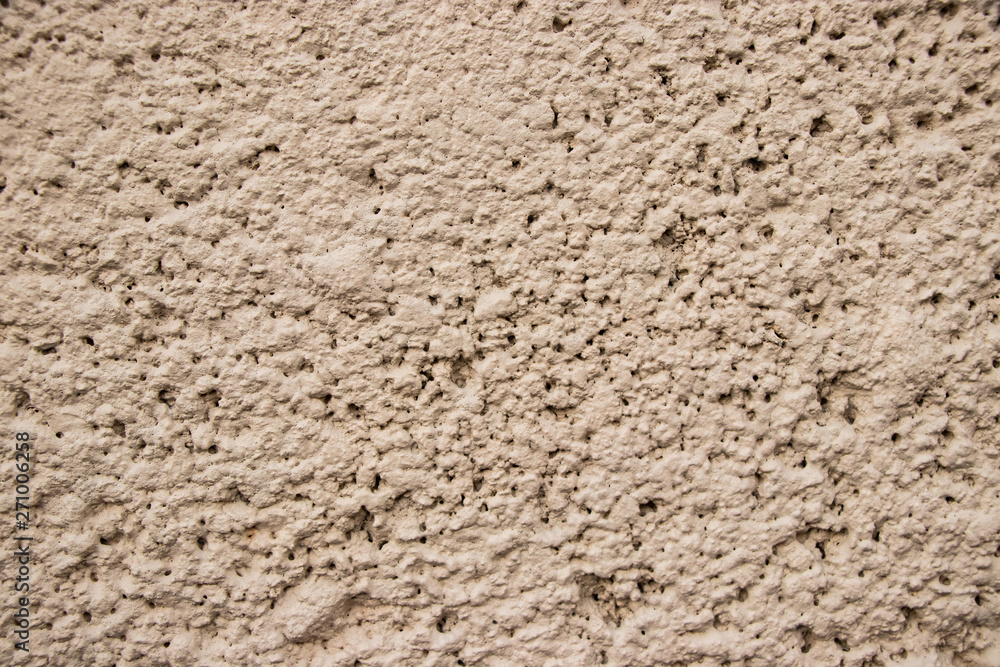 Beige stucco wall texture close up