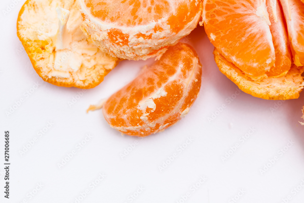 Peeled mandarin oranges on white background 