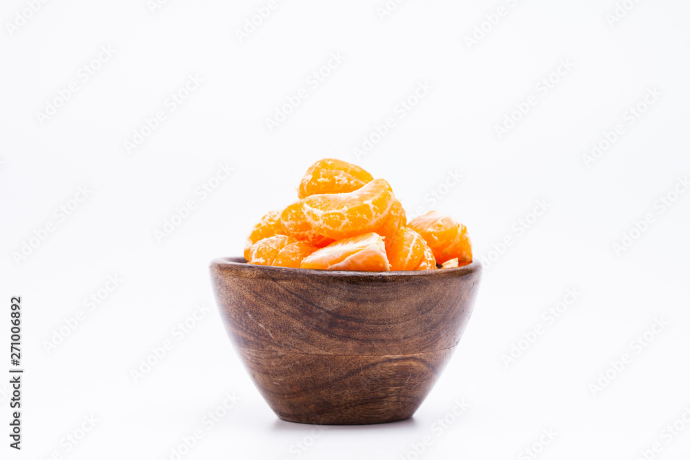 Peeled mandarin orange on wooden bowl Peeled mandarin orange on wooden bowl