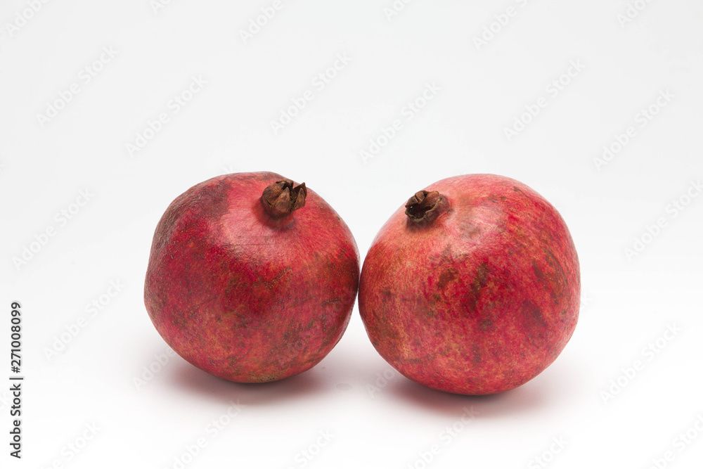 Two red pomegranate isolated on white background Two red pomegranate isolated on white background