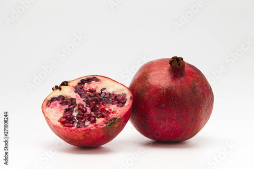 Two halfs pomegranate isolated on white background 