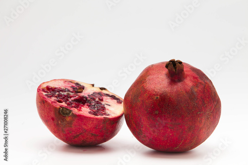 Two halfs pomegranate isolated on white background 