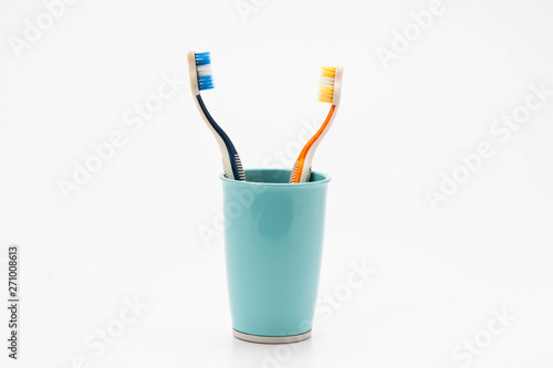 Toothbrush in plastic cup isolated on white background 