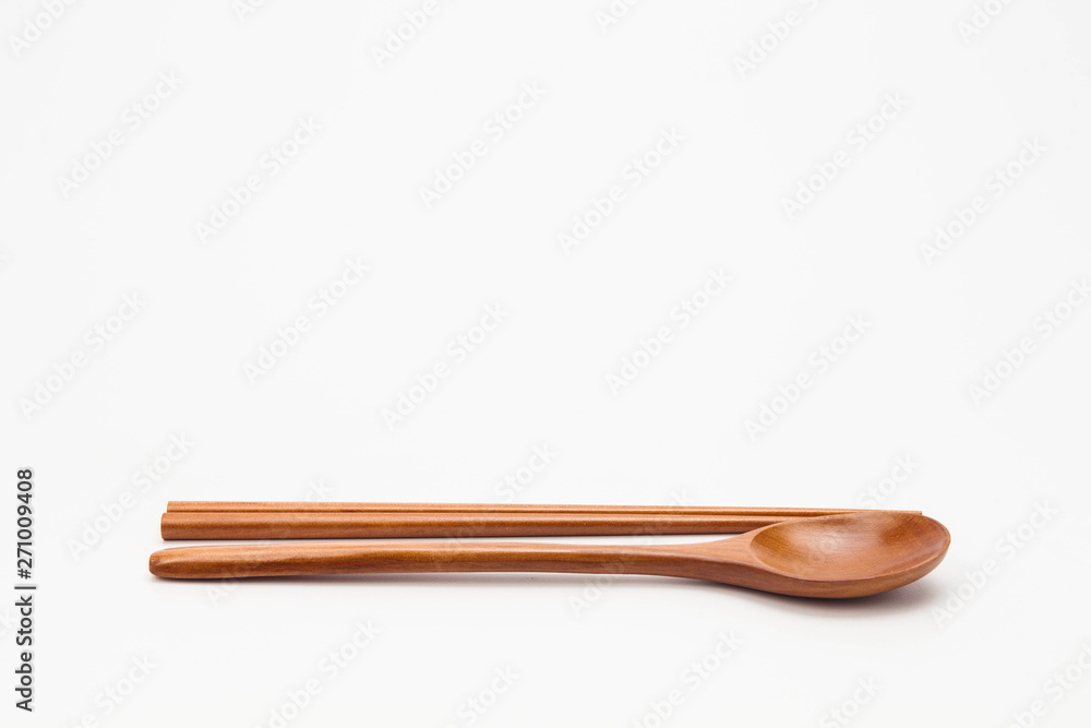 Wooden chopsticks and spoon isolated on white Wooden chopsticks and spoon isolated on white