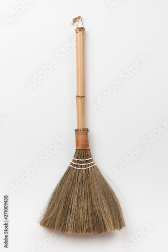 Broom on white wall