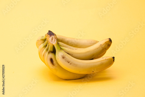 A Bunch of yellow bananas on yellow background